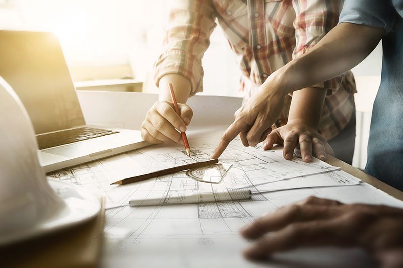 Architects Reviewing Plans Of House