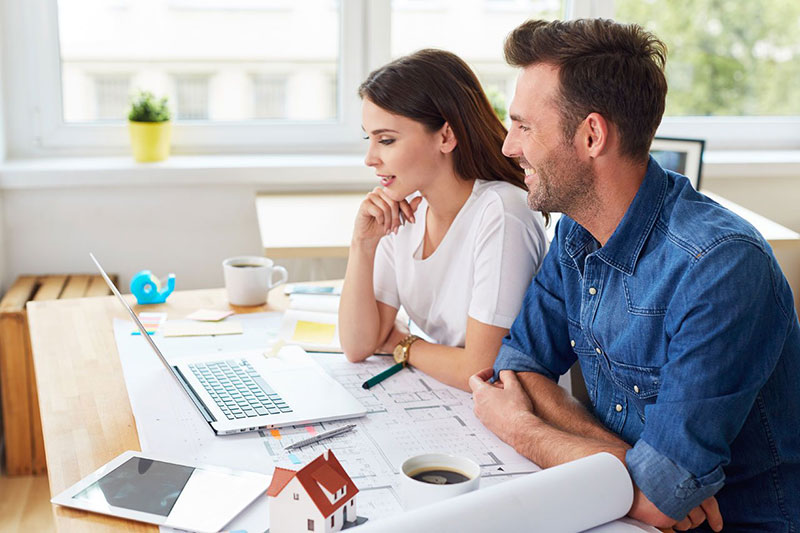 Man And Women Discussing Property Statistics